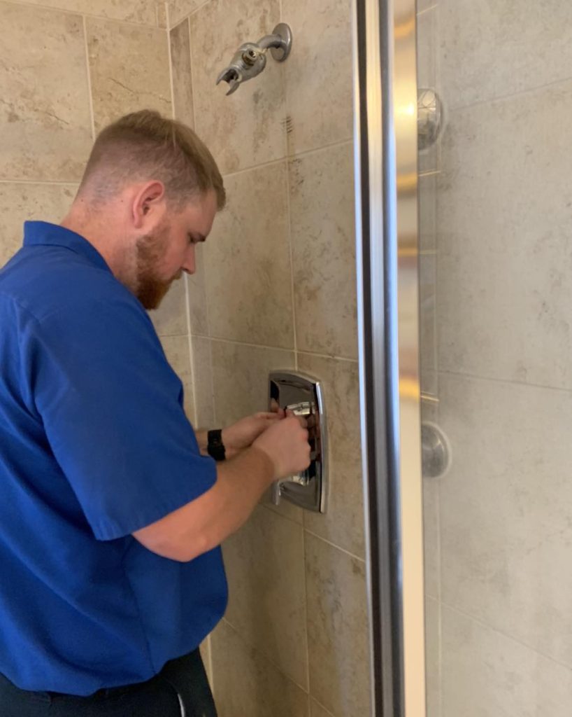 cinco ranch plumber installs a shower handle for a bathroom remodeling project x
